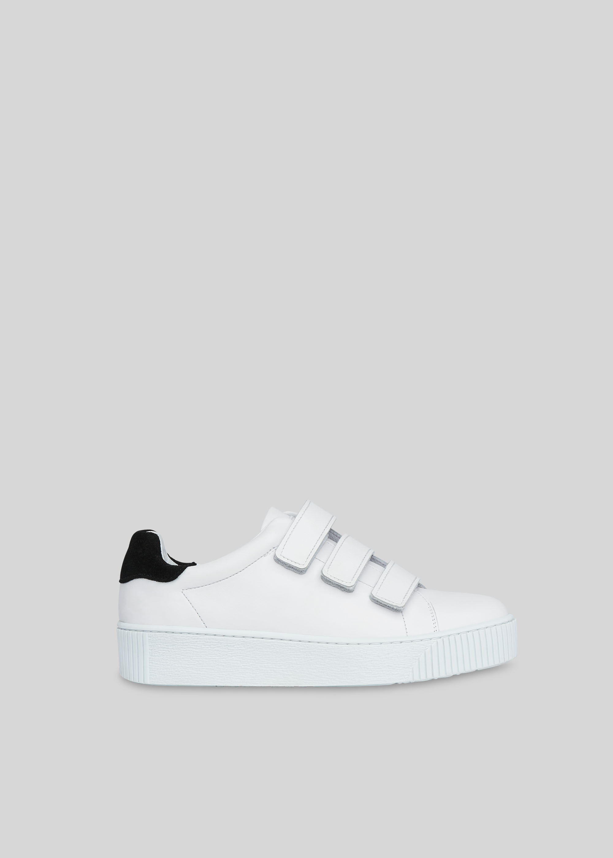 white trainers with velcro fastening