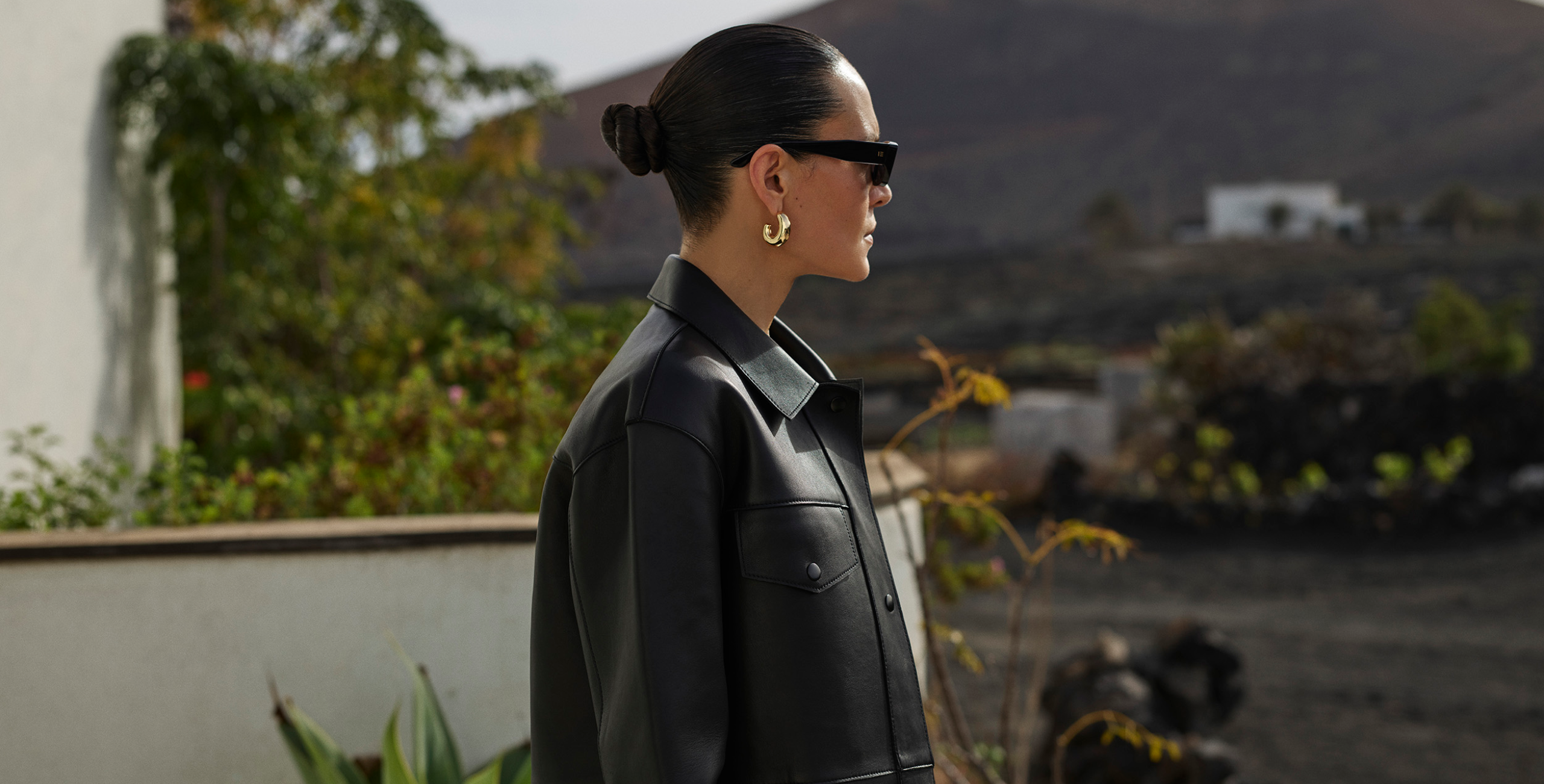 woman wearing blue jeans and black leather jacket