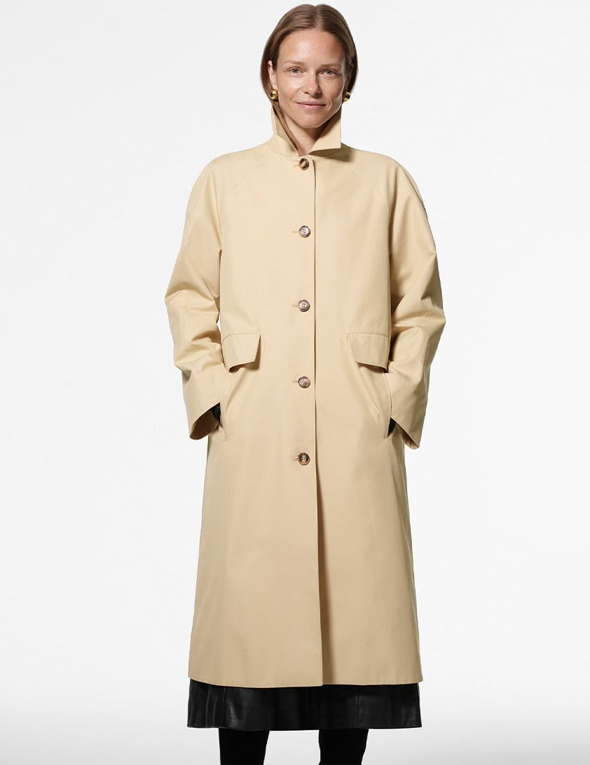 Woman wearing a cream utility style jacket with chest pockets layered for Whistles 15% off everything promotion