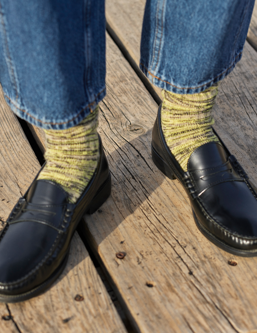 Woman wearing black loafers