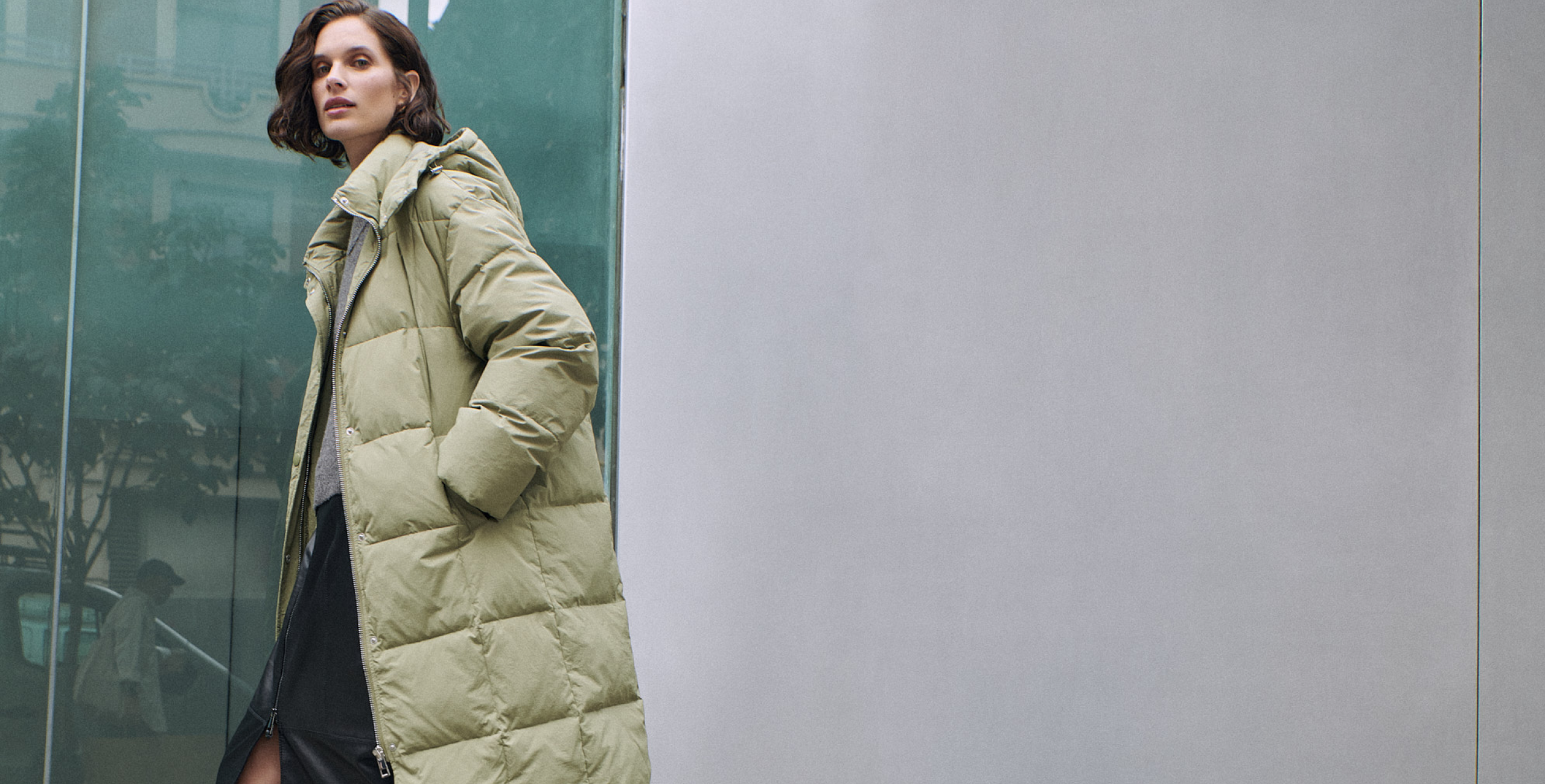 2 woman wearing green long puffer coats
