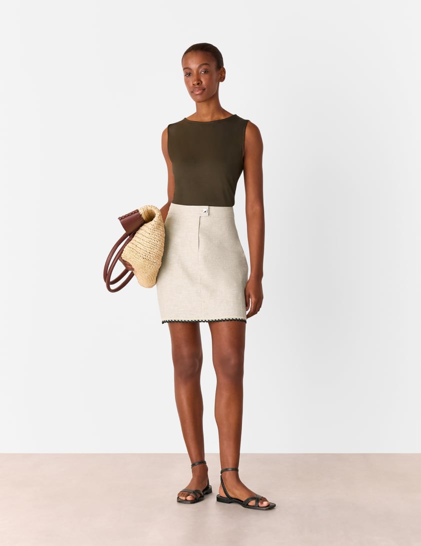 woman wearing netural linen mini skirt and vest