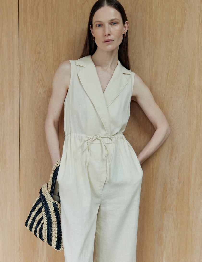 Woman wear plain cream linen jumpsuit