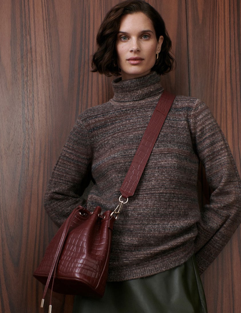 Woman wearing brown roll neck jumper