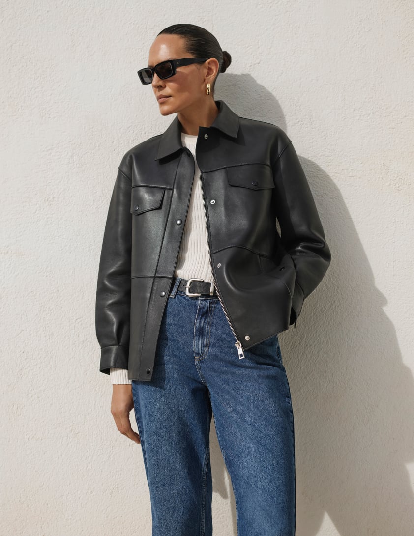 Woman wearing black leather jacket, paired with denim jeans