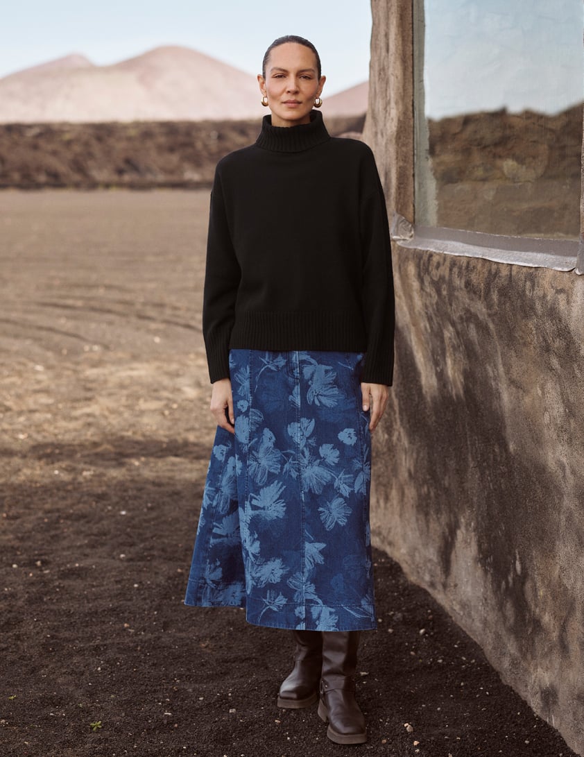 woman wearing black jumper and denim skirt