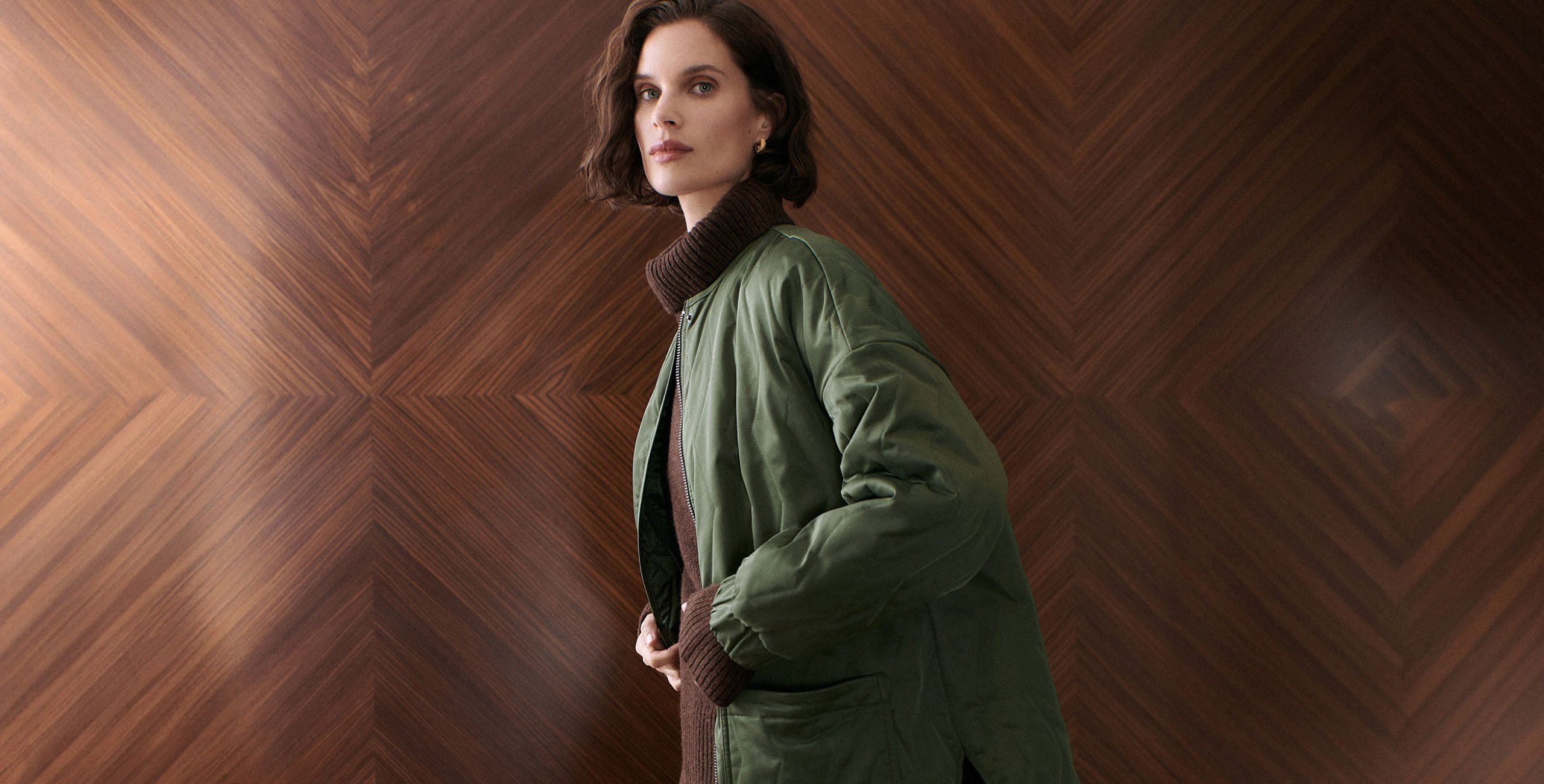 woman wearing green quilted jacket