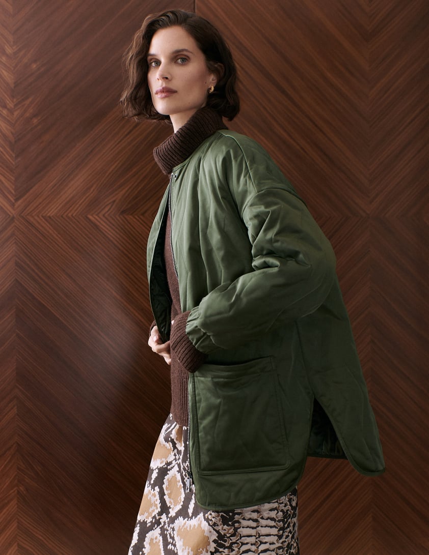 woman wearing green quilted jacket