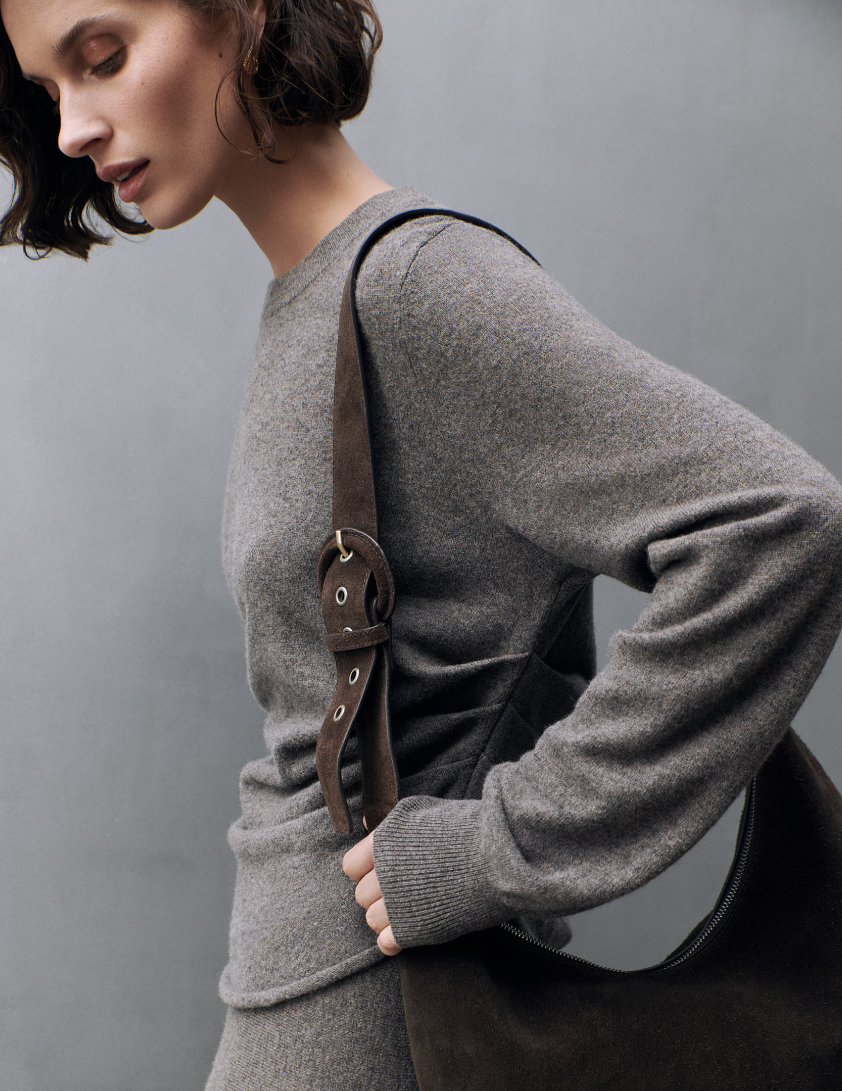 2 woman wearing dark grey knitted top