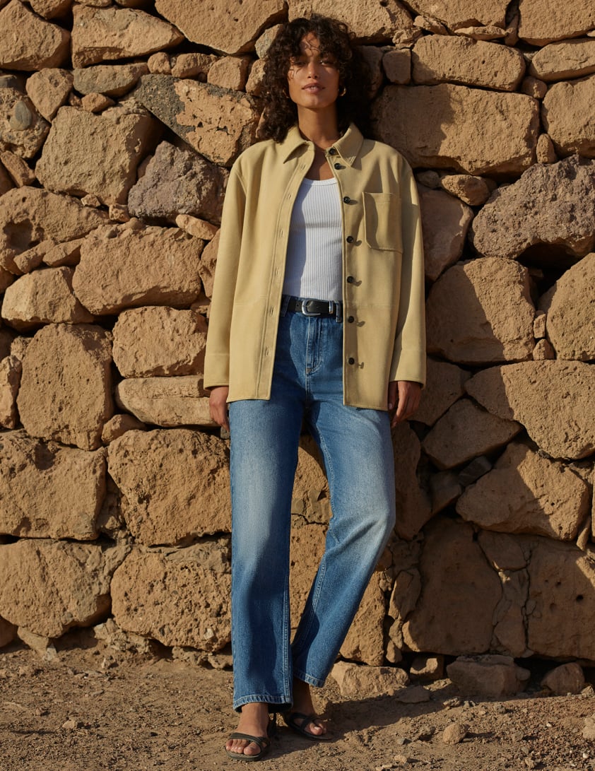 woman waerring denim jeans and suade jacket