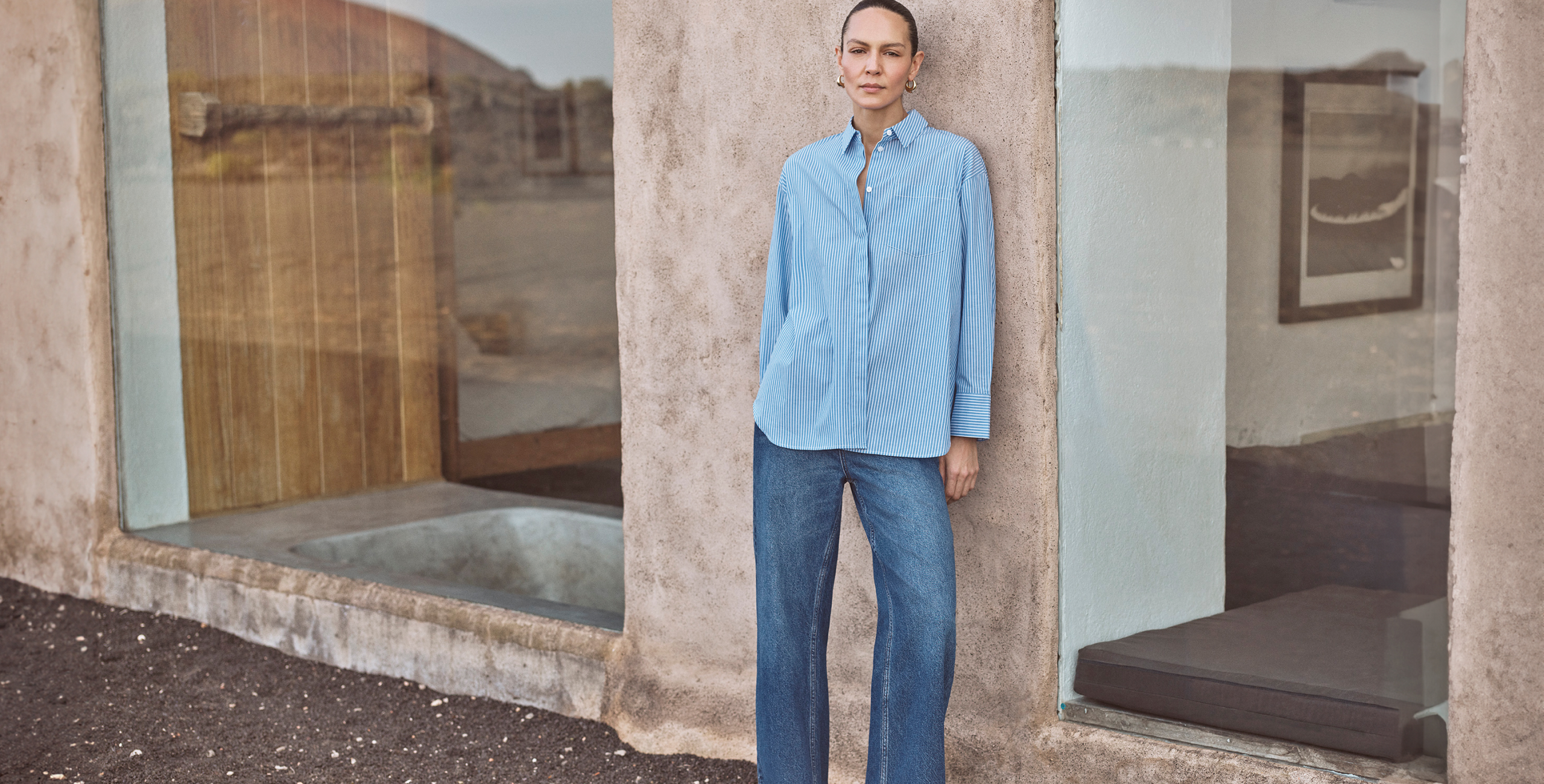 woman wearing blue stripe shirt and jeans