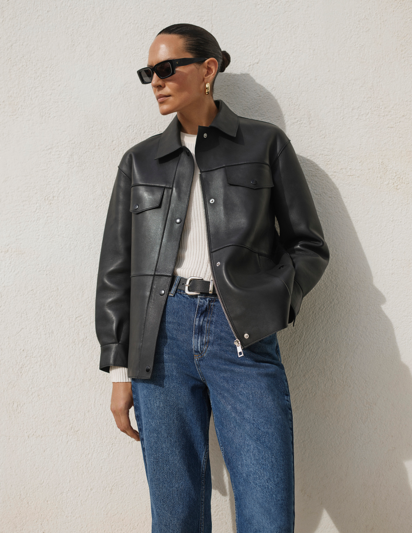 woman waerring denim jeans and black leather jacket