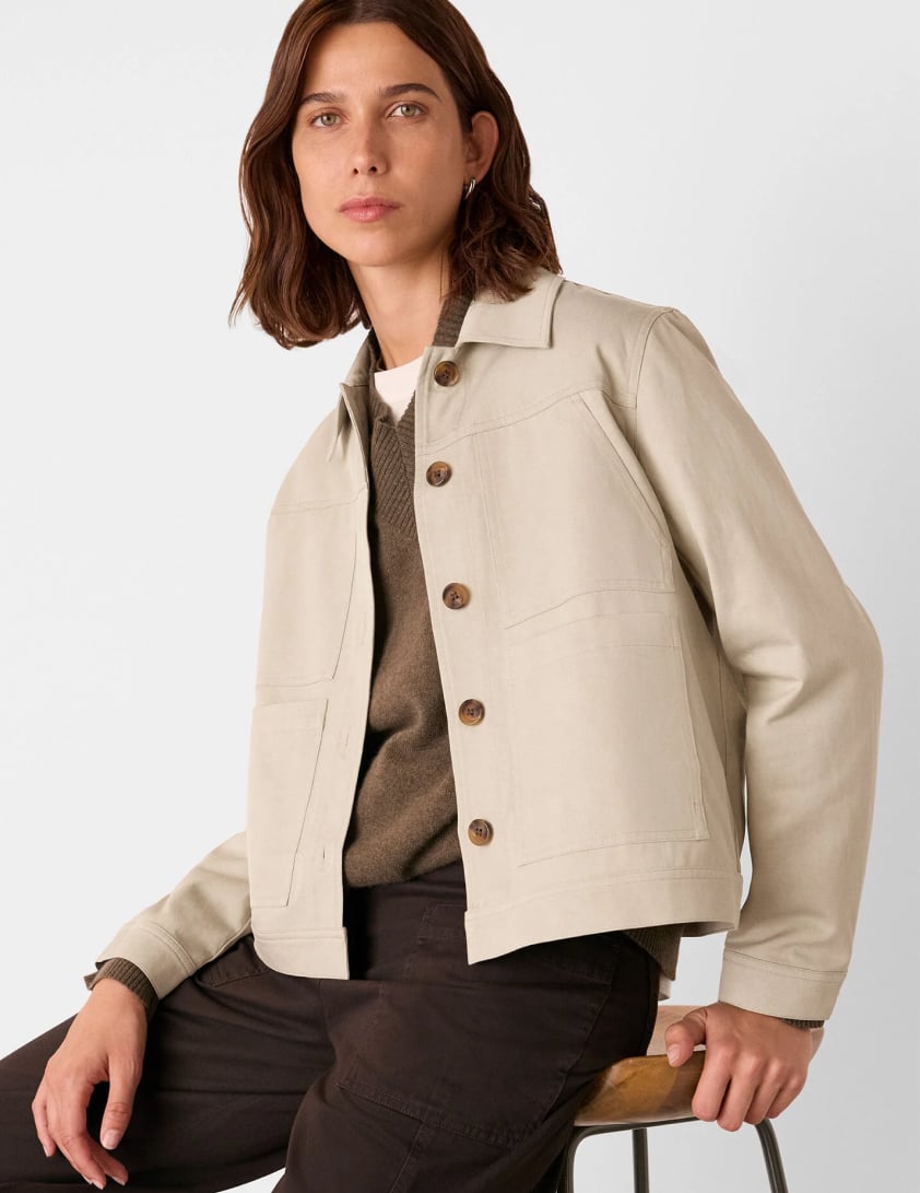 Woman wearing a cream utility style jacket with chest pockets layered for Whistles 25% off everything labor day promotion
