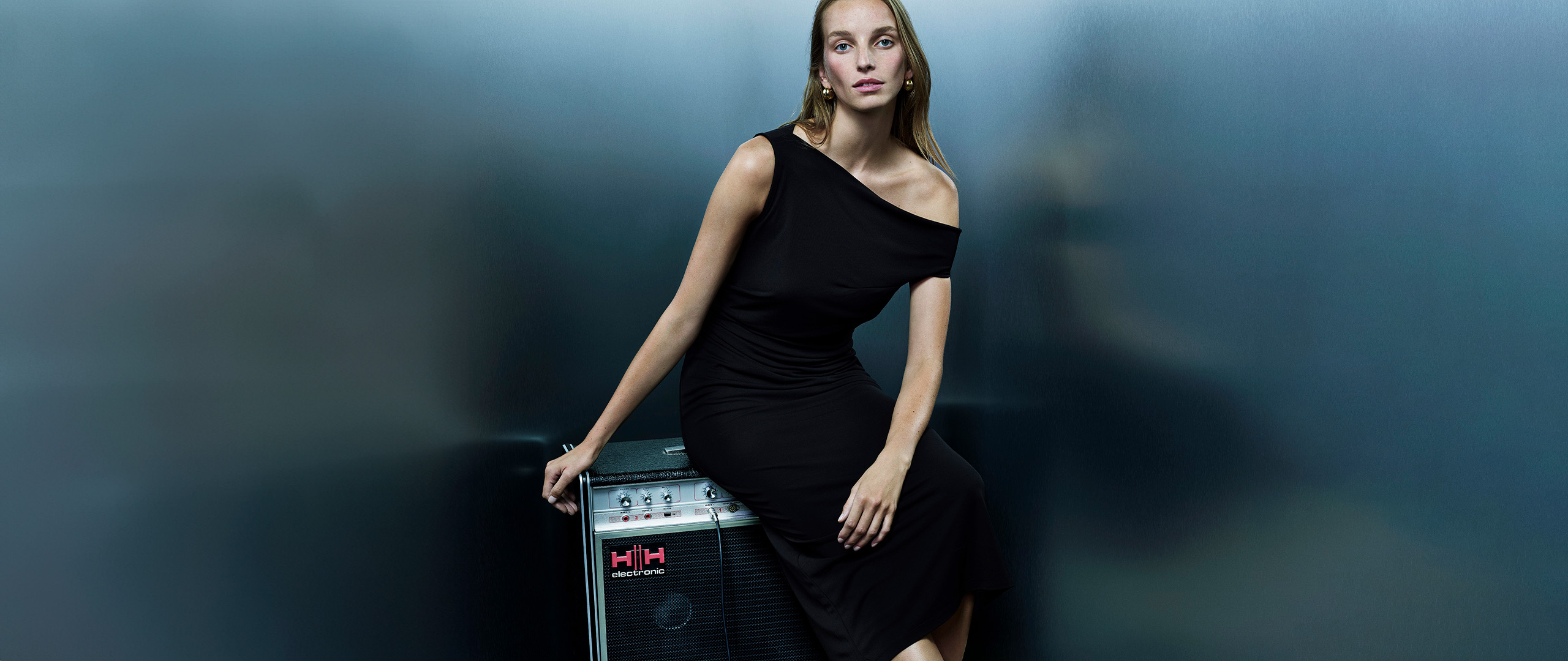 Whistles black leather ankle boots for women, Chelsea style with elasticated side panels and pull tab, shown on stool