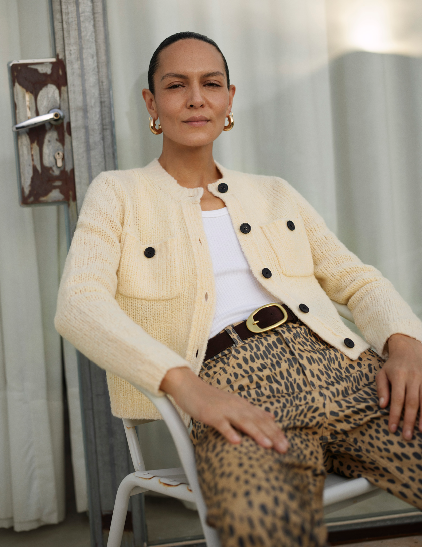 Woman wearing cream cardigan and lepord pint trousers