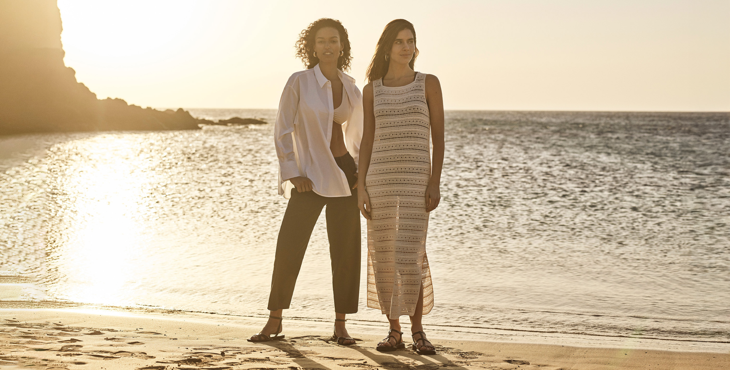 2 women wearing linen shirt and trousers and a dress
