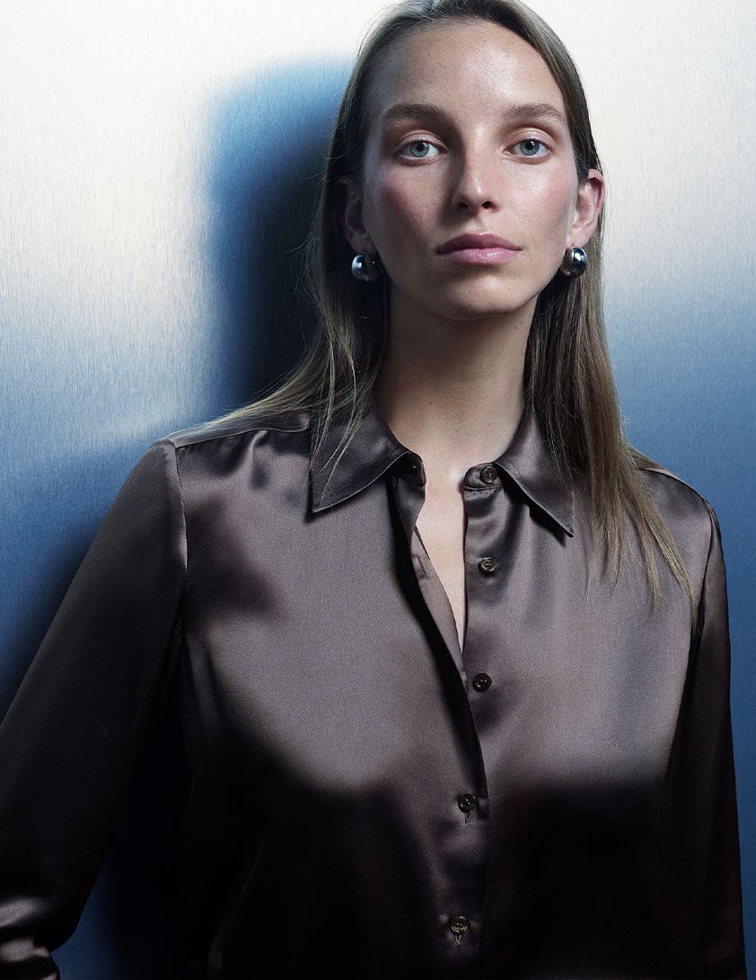 Woman wearing a Whistles brown satin shirt