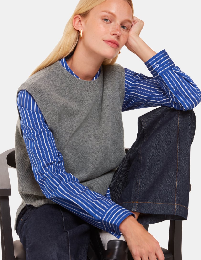 Woman wearing stripped shirt and grey woll tank top