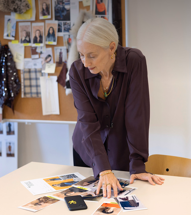 Mo Riach laying out look prints at a studio table